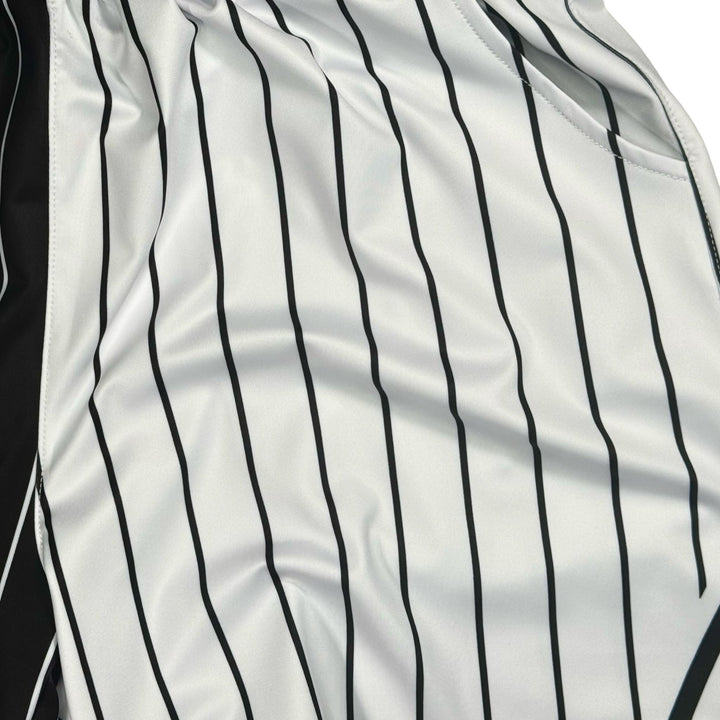 Closeup of materials of Black and white pinstripe shorts on a white background