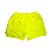 Bright neon yellow shorts on a white background