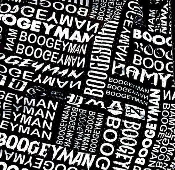 Pattern of 'Boogeyman' text on a black background fabric closeup