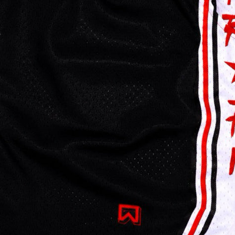 Close-up of a black athletic mesh jersey with a vertical white side stripe outlined in red and a small red logo near the bottom.