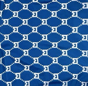 Closeup of fabric of Blue patterned shorts with white trim on a white background