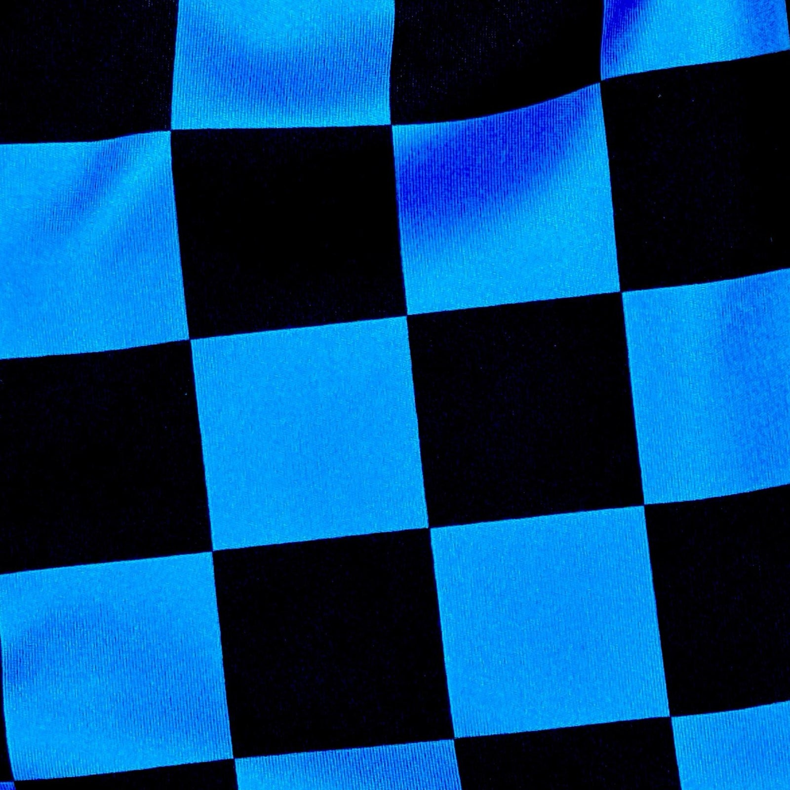 Blue and black dry fit shorts with checkerboard design fabric closeup
