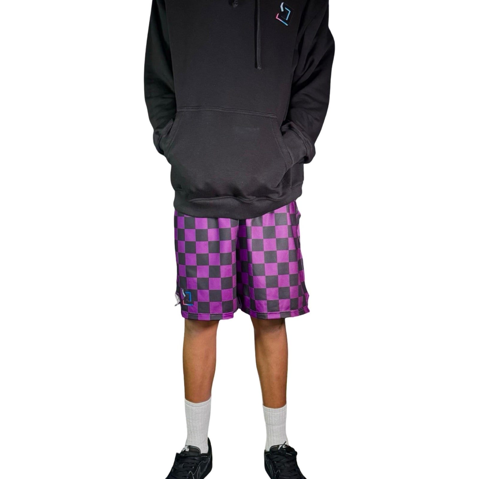 Person wearing a black hoodie and purple checkered shorts on a white background