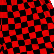 Red and black checkered shorts on a white background texture closeup