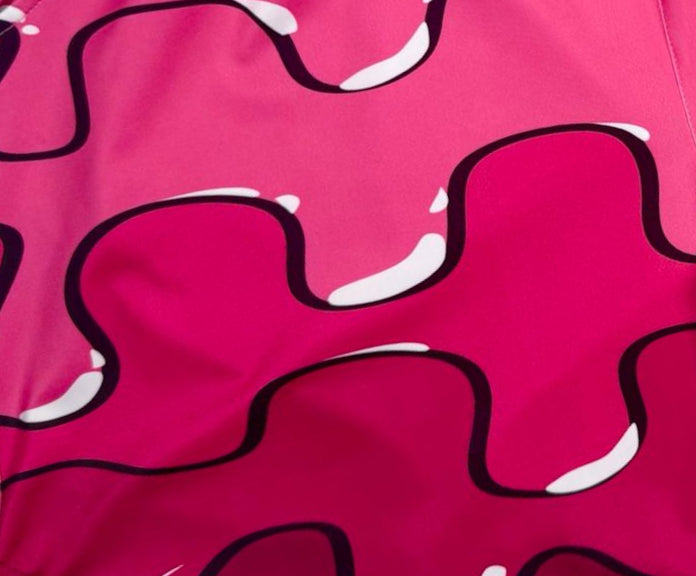 Close-up of a pink fabric with black and white abstract pattern
