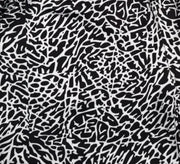 Closeup view of texture of Black and white elephant print pattern soft dry fit shorts on a white background