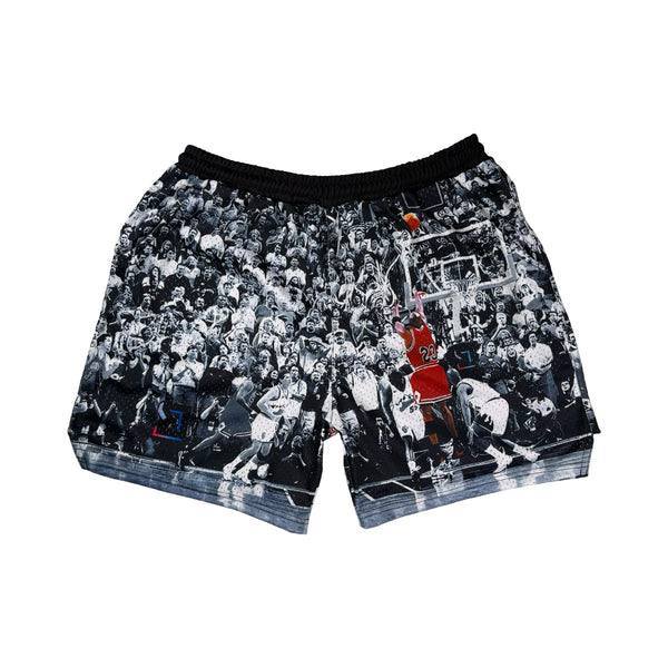 Shorts with a black and white vintage game winner photo design featuring a basketball player in action on a white background.