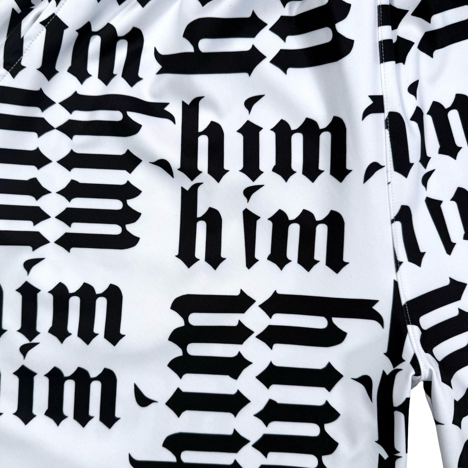 Closeup of Pattern of the word 'him' repeated in black and fabric on a white background