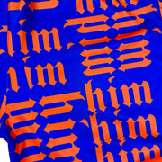 Close up view of texture of Purple soft dry fit shorts with repeating orange him text pattern on a white background