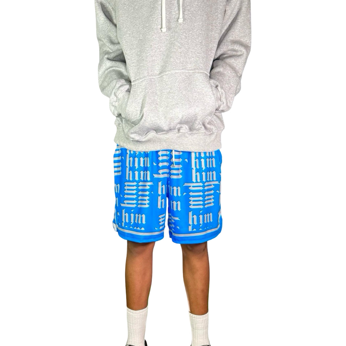 Person wearing a gray hoodie and blue shorts with silver text on a white background
