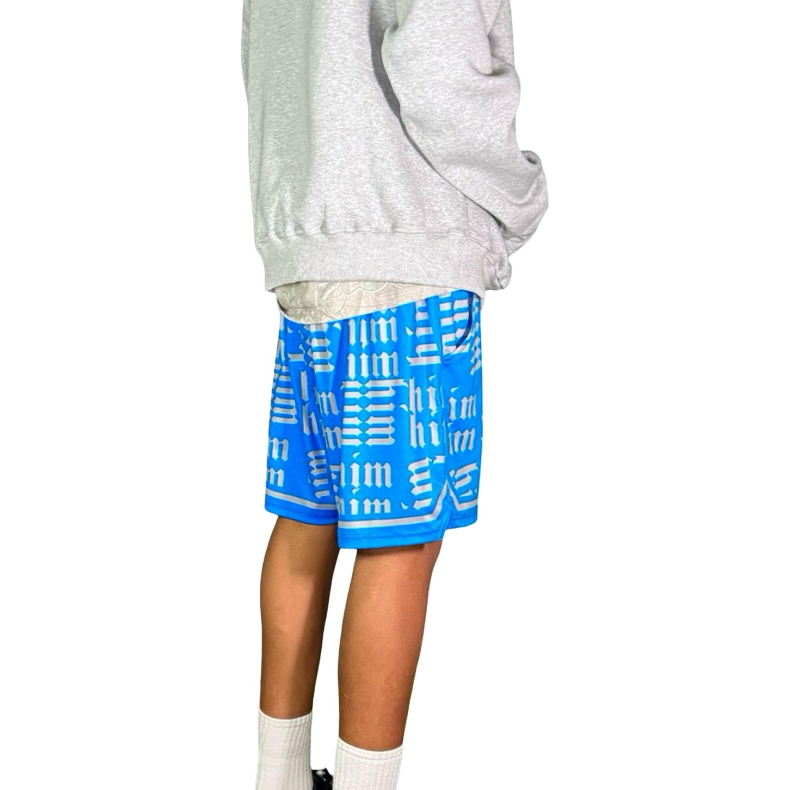 Person wearing a gray hoodie and blue shorts with silver text on a white background