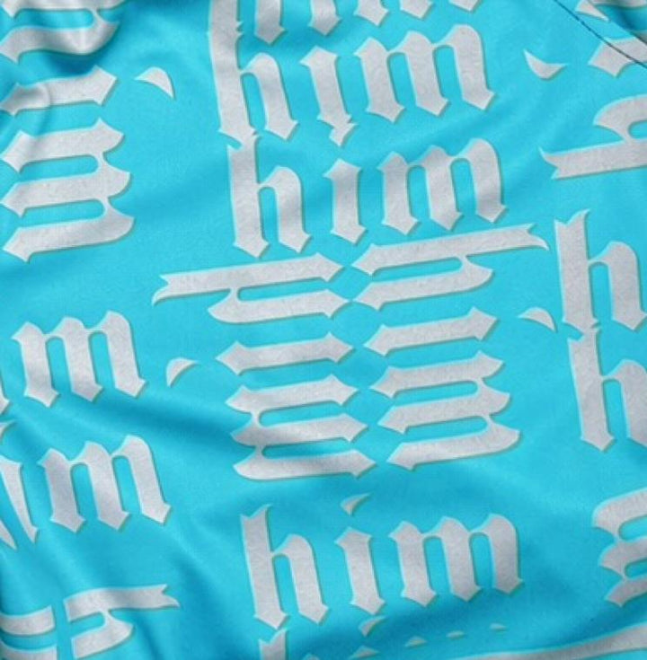 Closeup texture view of Blue shorts with silver him text pattern