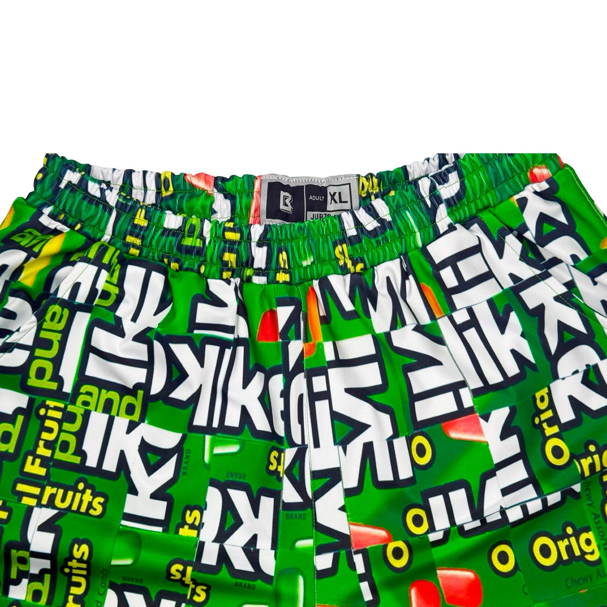 Green shorts with fruit candy box mosaic style pattern