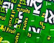 Green shorts with fruit candy box mosaic style pattern texture closeup