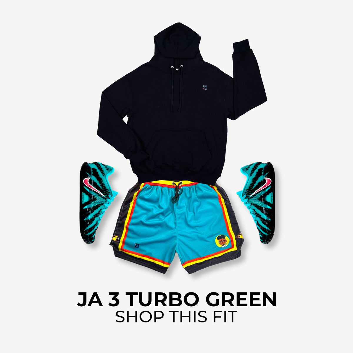 Black hoodie, blue shorts with colorful accents, and green sneakers on a light gray background.