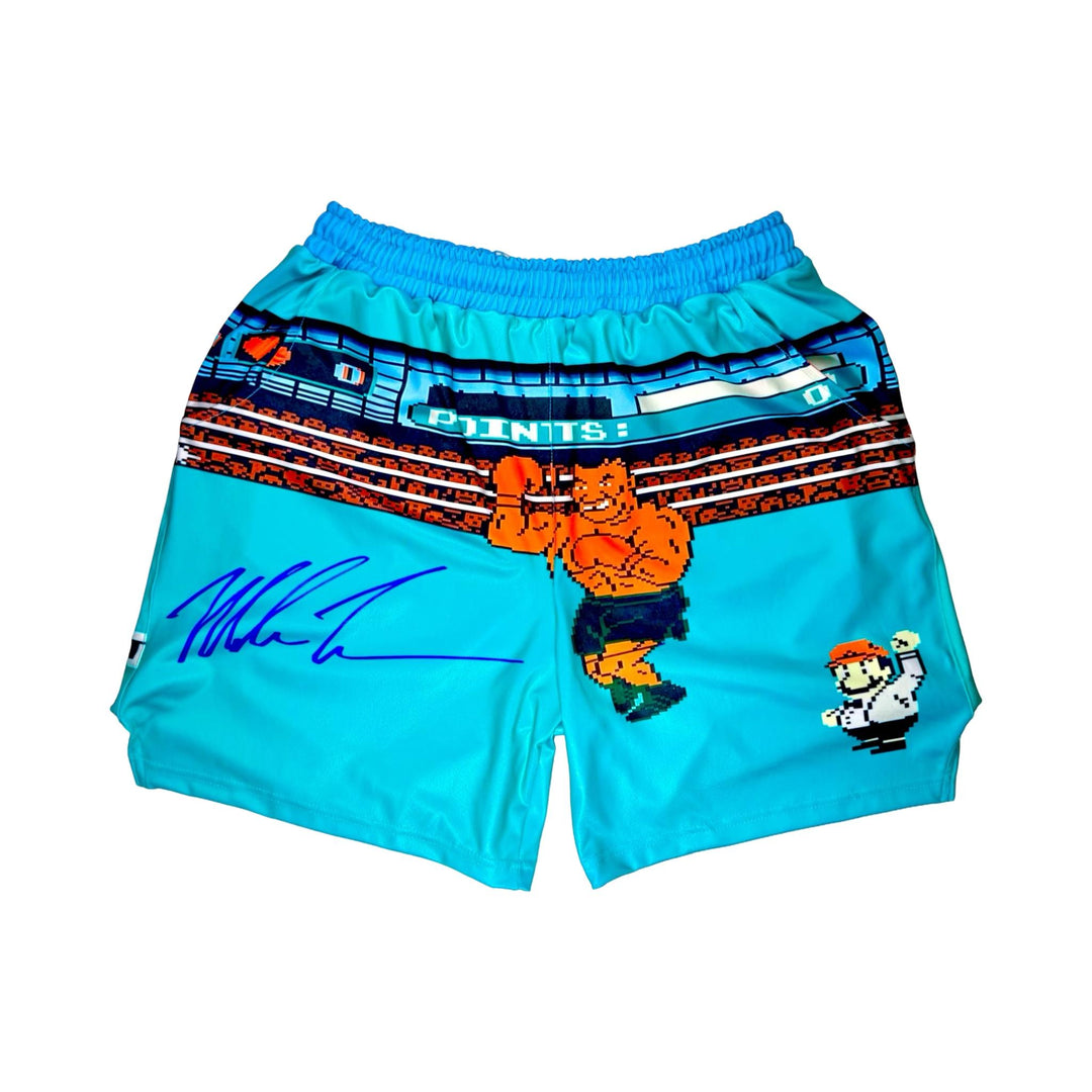 Turquoise dry fit shorts with pixel punch boxing game characters on a white background