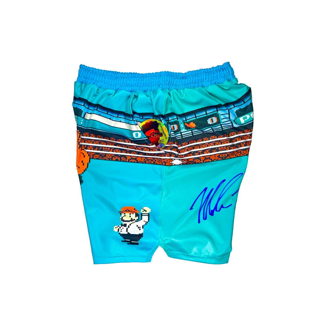 Side view of Turquoise dry fit shorts with pixel punch boxing game characters on a white background