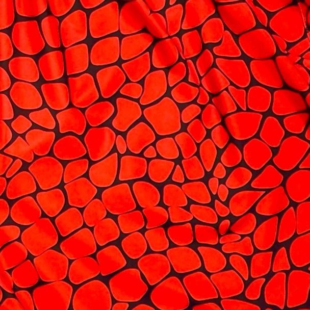 Red shorts with black gator/zombie pattern on a white background