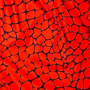 Red shorts with black gator/zombie pattern on a white background