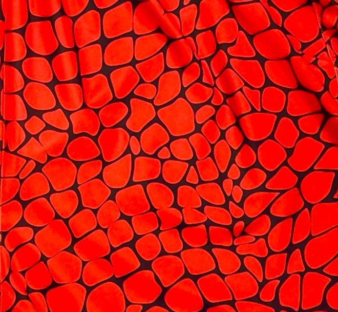 Red shorts with black gator/zombie pattern on a white background