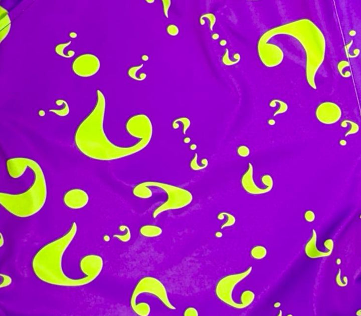 Purple fabric with green question marks and droplets