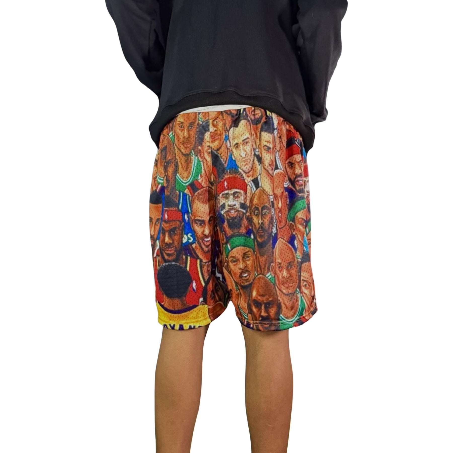 Shorts with a colorful graphic design of various faces on a white background