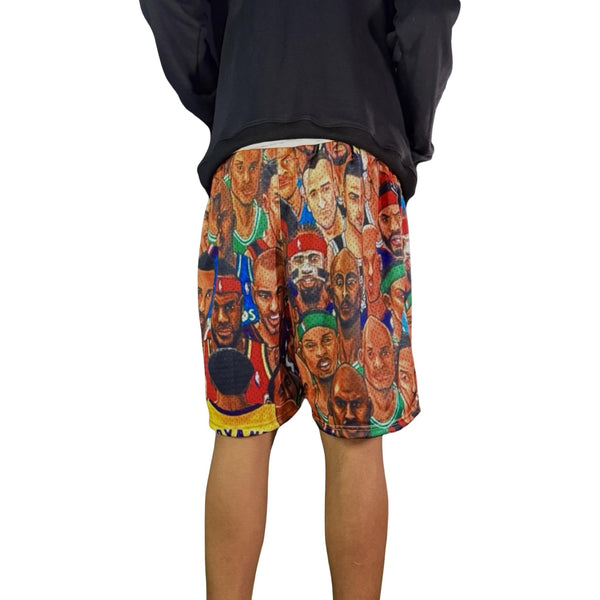 Shorts with a colorful graphic design of various faces on a white background