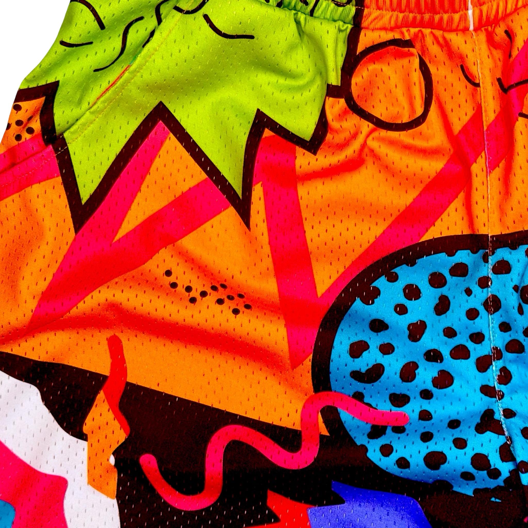 Closeup texture view of Multicolored 90's themed mesh dry fit basketball shorts with various colorful shapes on a white background