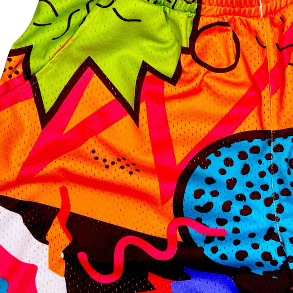Closeup texture view of Multicolored 90's themed mesh dry fit basketball shorts with various colorful shapes on a white background