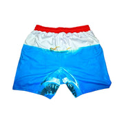 Blue swim shorts with shark design on a white background