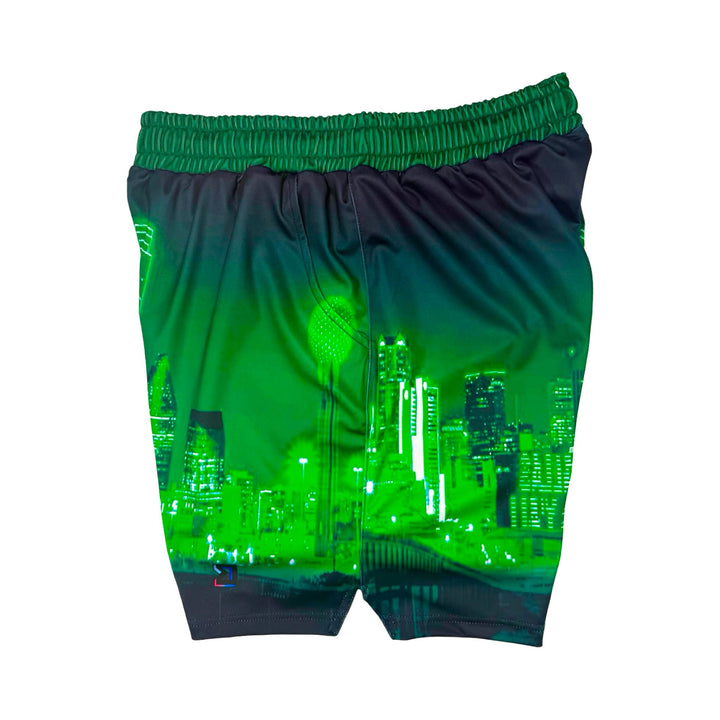 Side view of Skyline green dry fit shorts with skyline graphic on white background.