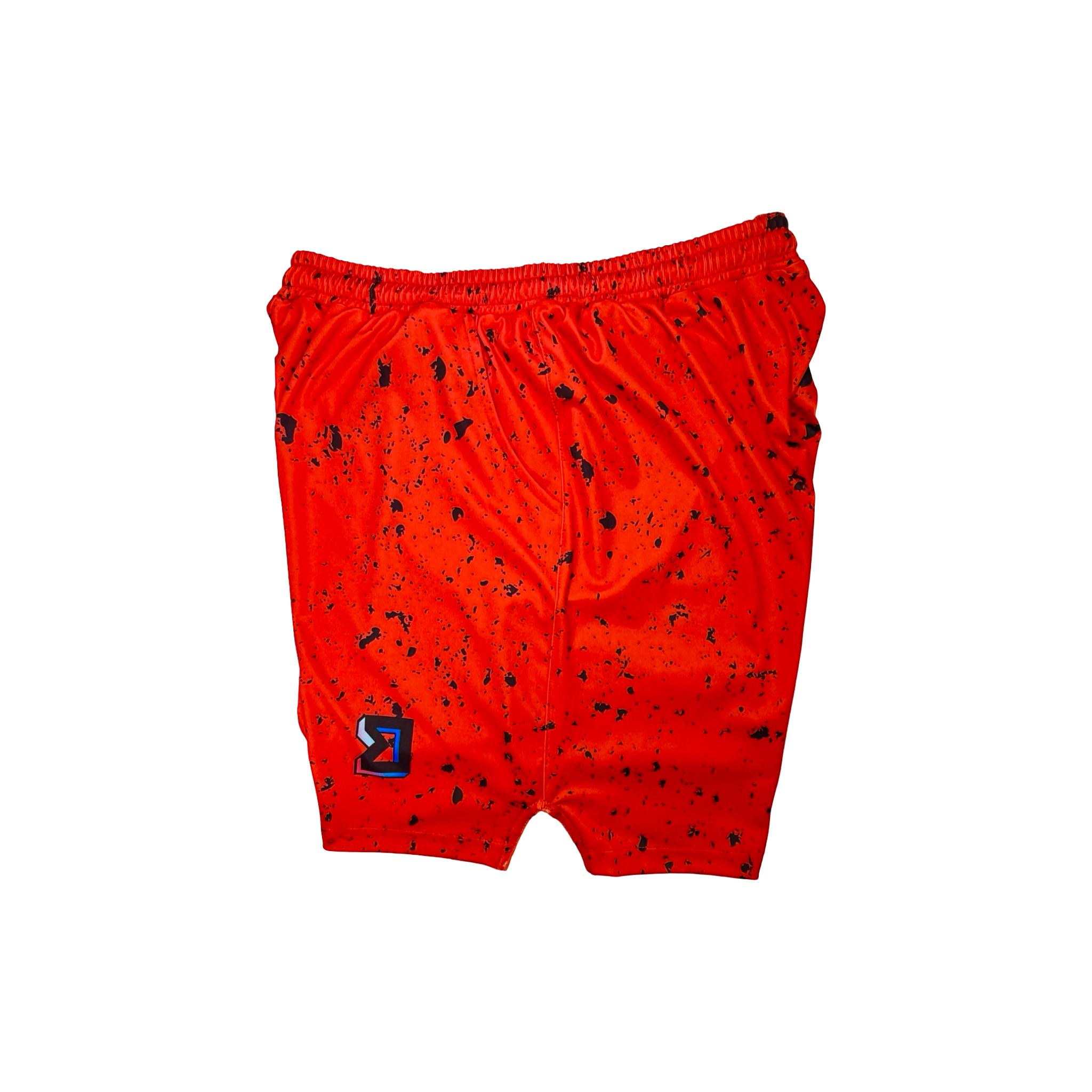 Side view of Red soft dry fit basketball shorts with black speckle repeating pattern on a white background