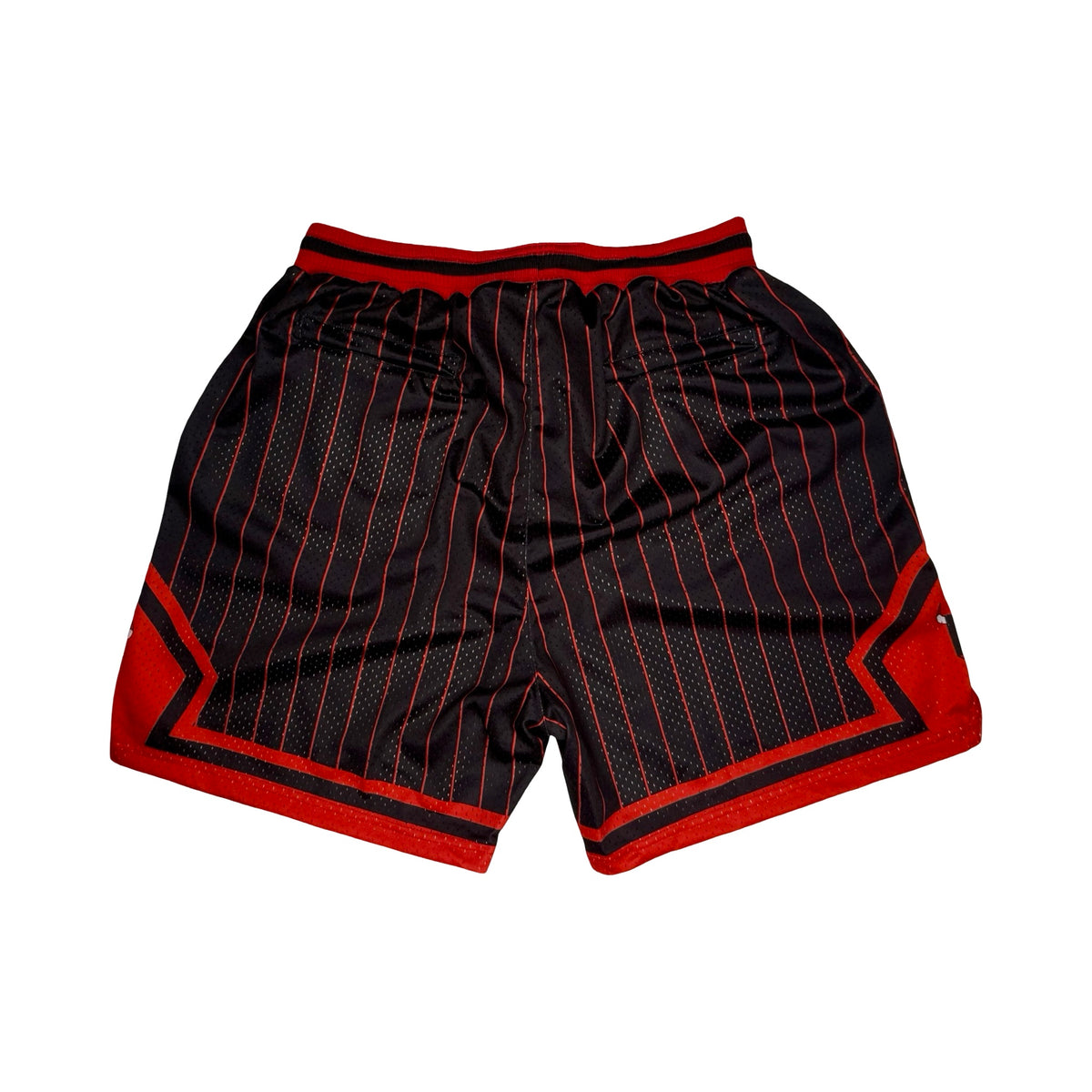 Black basketball shorts with thin red pinstripes, red side panels, and a red waistband, shown flat on a white background.