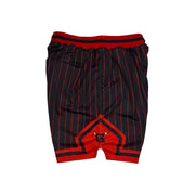 Black and red basketball shorts with thin red pinstripes, a red waistband, and a red geometric logo patch on the front.
