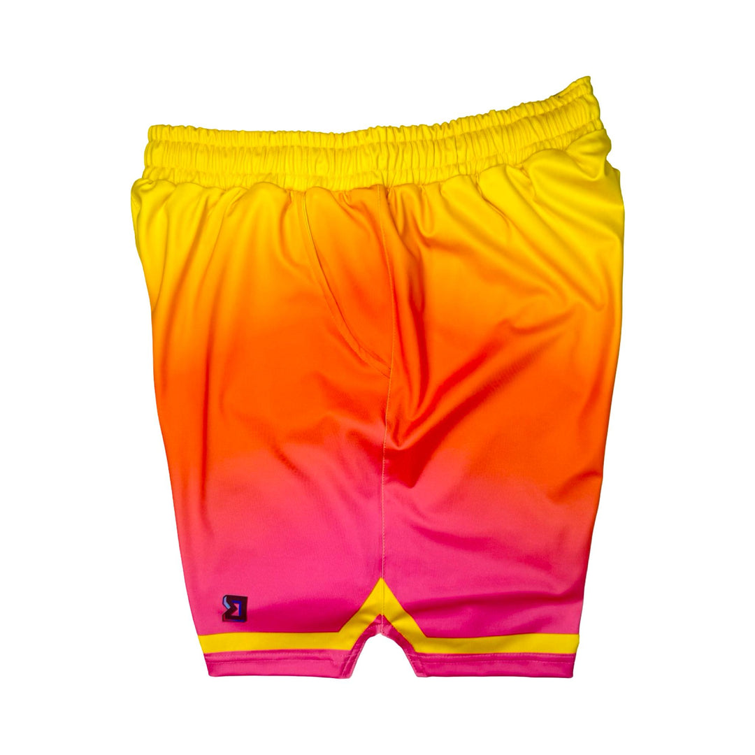 Side View of Sunburst yellow to pink gradient dry fit shorts with yellow stripe on white background.