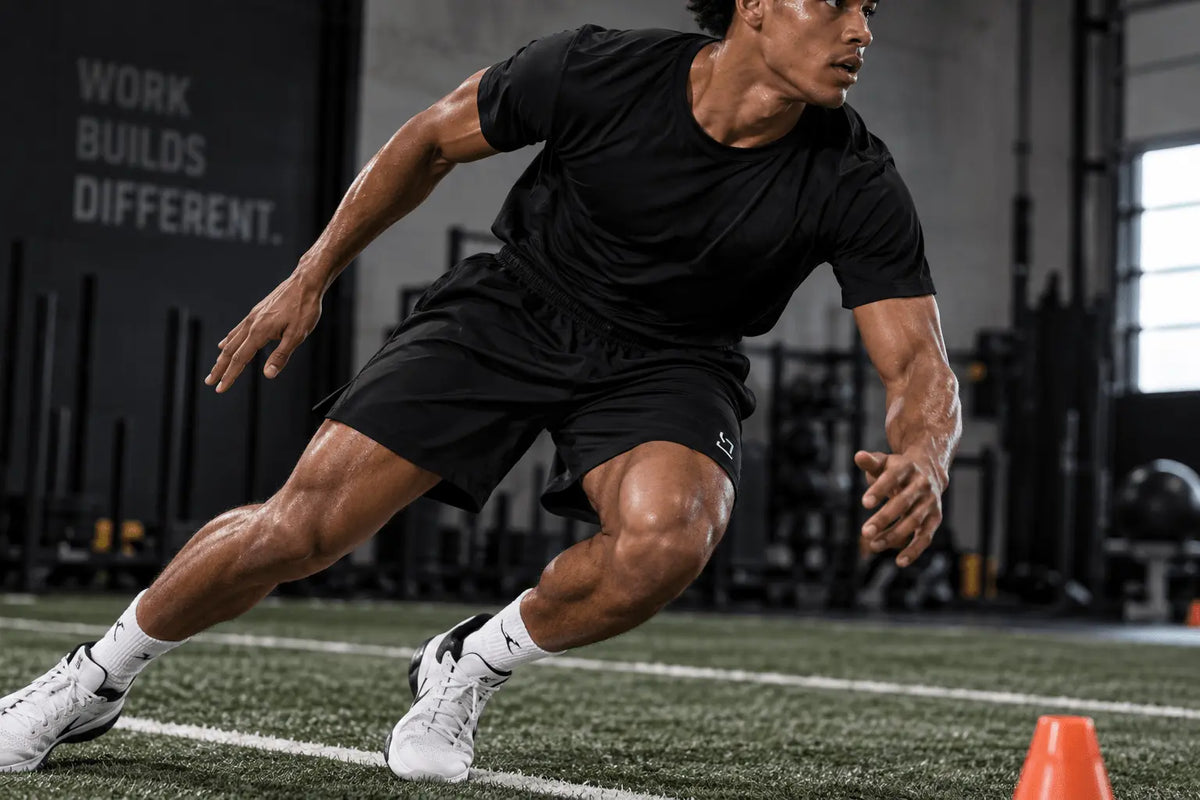Athletic movement cut of TRAPN™ TRAINING™ shorts during a change-of-direction drill.