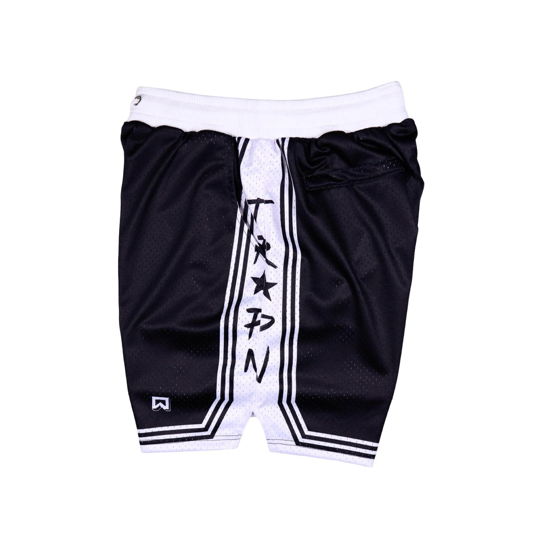 Side view of Black shorts with white accents on a white background