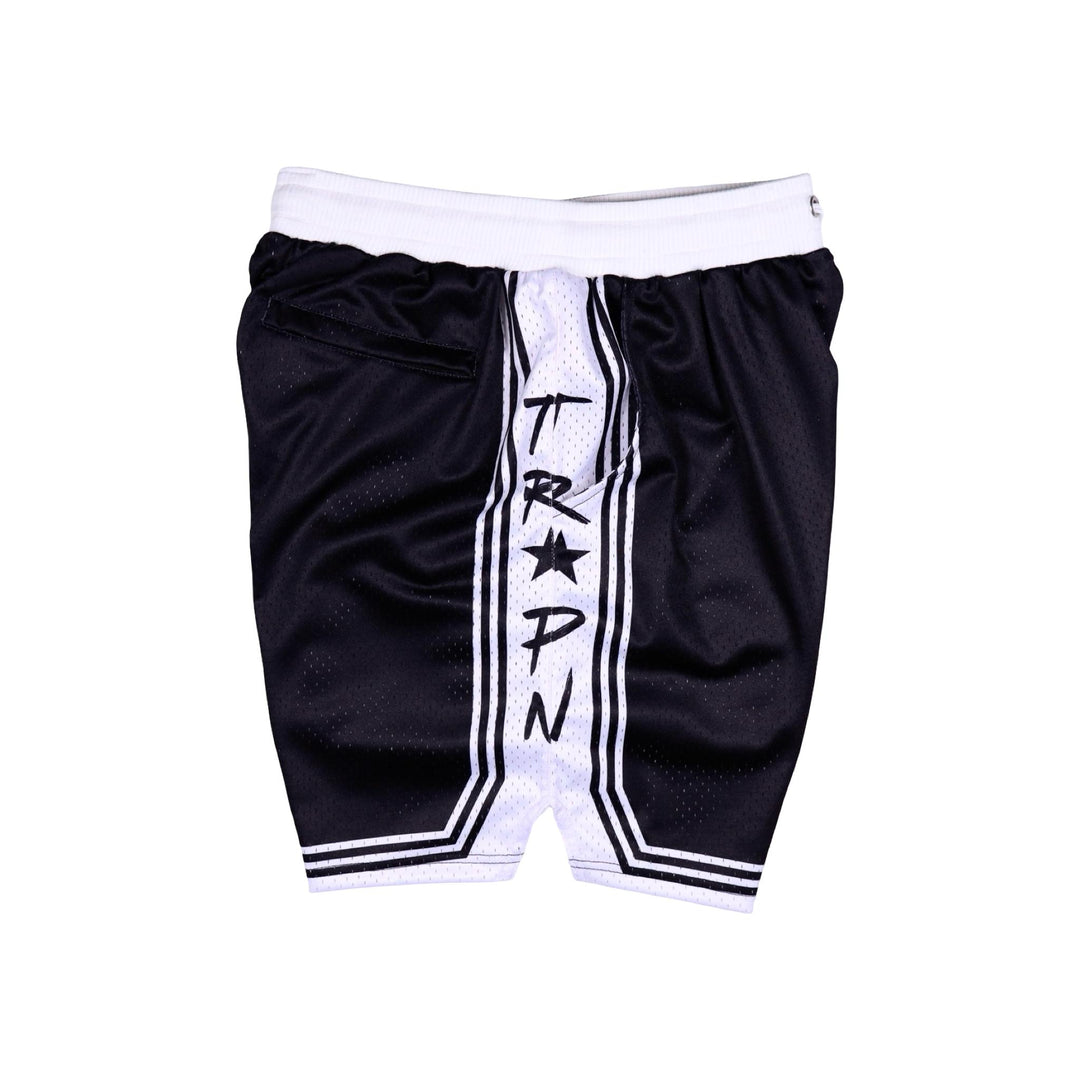 Other side view of Black shorts with white accents on a white background