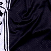 Close-up of black textured fabric with a white and black patterned background