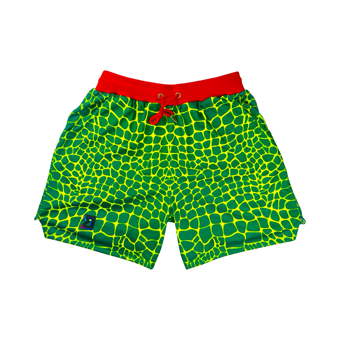 Trap Grinch Mesh Pro basketball shorts with neon green reptile pattern, red pro waistband, and zippered pockets by Trap’N Shorts.
