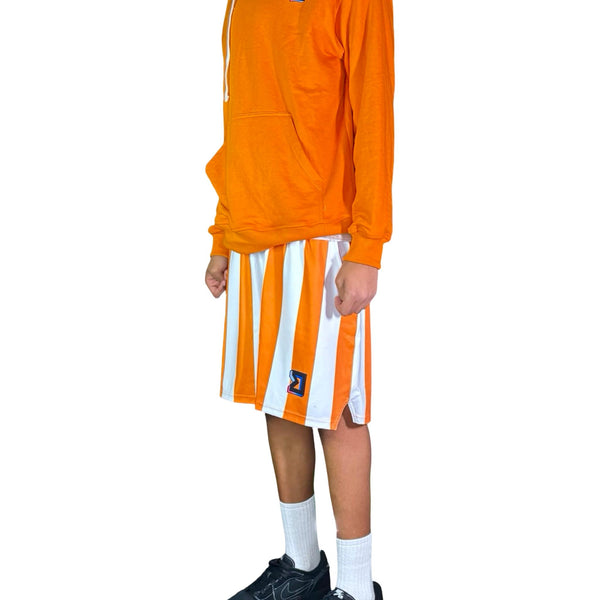 Person wearing an orange long-sleeve shirt and white shorts with orange stripes on a white background