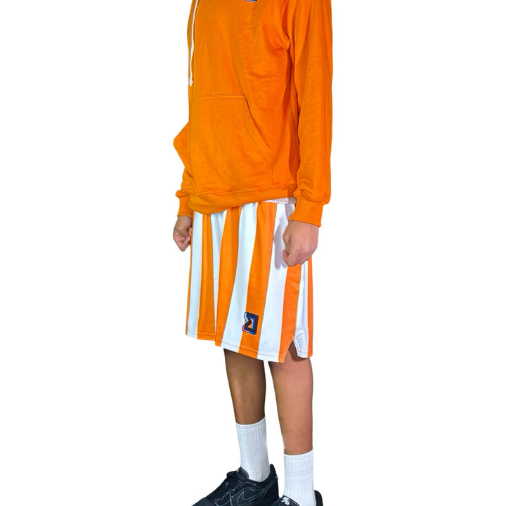 Person wearing an orange long-sleeve shirt and white shorts with orange stripes on a white background