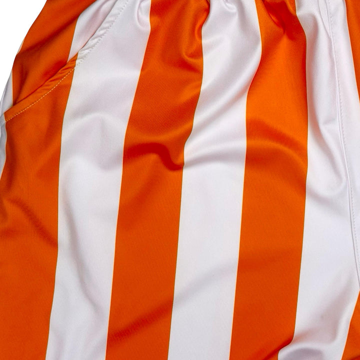 Close-up of orange and white striped shorts fabric