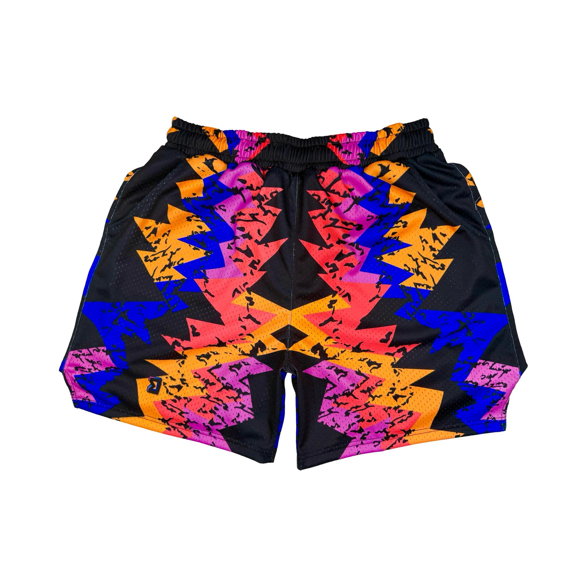 Colorful geometric patterned shorts on a white background
