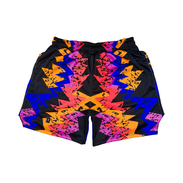 Colorful geometric patterned shorts on a white background