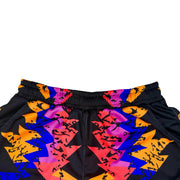 Colorful geometric patterned shorts on a white background