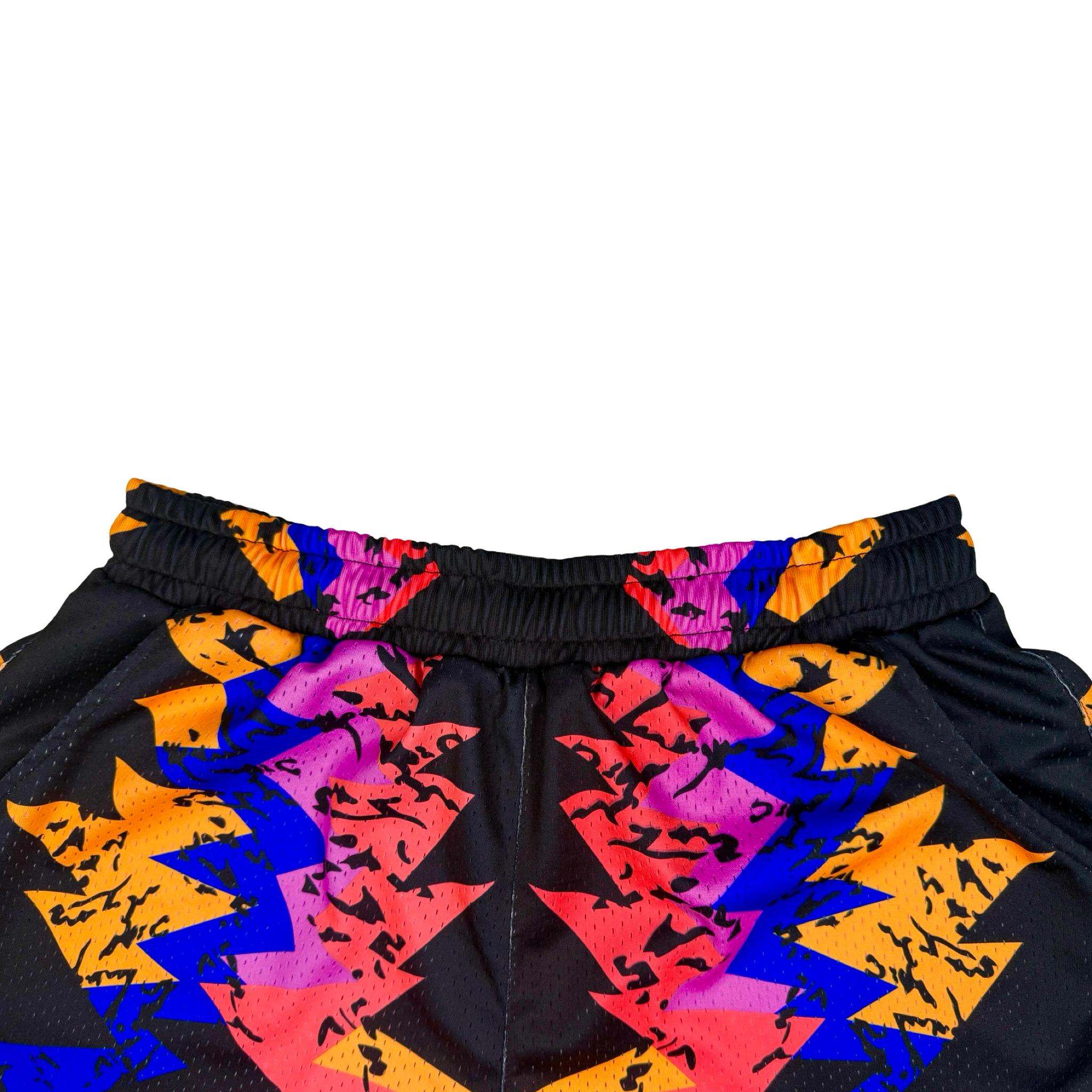Colorful geometric patterned shorts on a white background