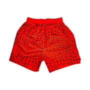 Red shorts with black gator/zombie pattern on a white background