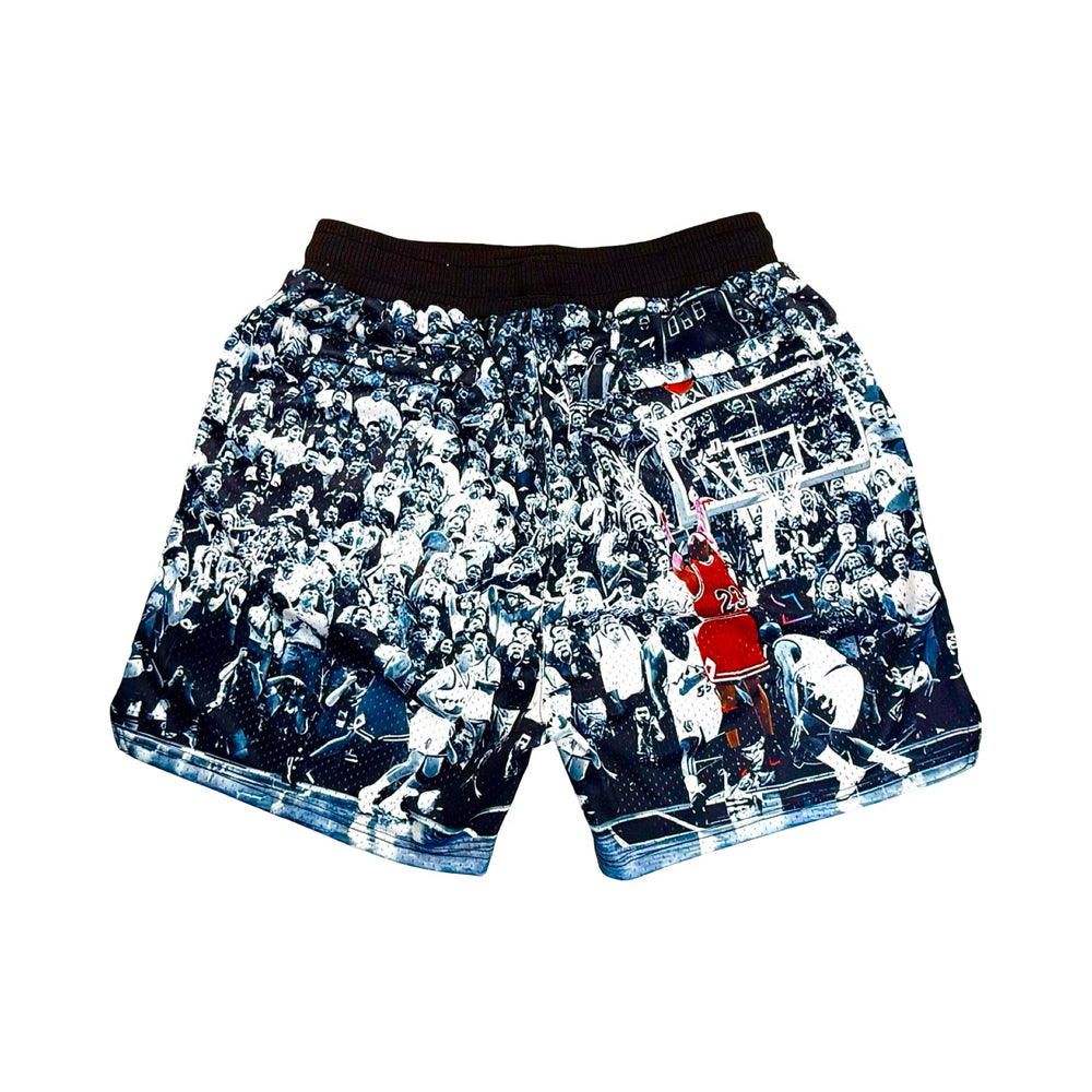 Black white and red shorts with a basketball player taking a historic game winning shot
