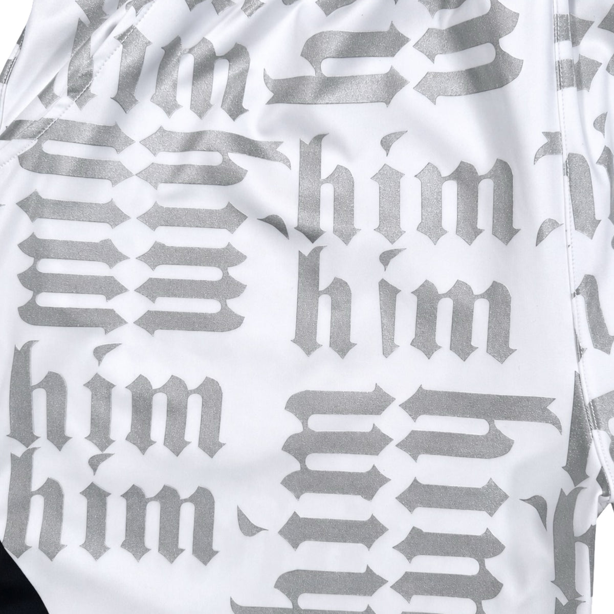 White silver and black him shorts with silver text pattern and black trim closeup